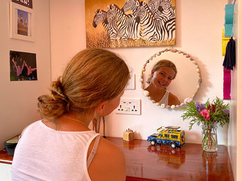 High angle view of woman with teddy bear on table at home