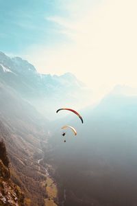 People paragliding against sky