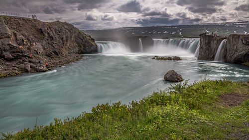 Thundering massive godafoss waterfall during a brief icelandic summer