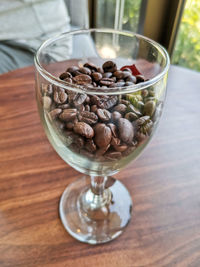 High angle view of coffee beans in glass on table
