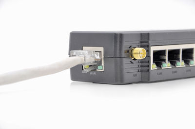 Close-up of telephone booth against white wall