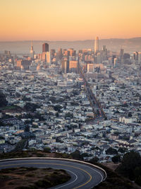 Aerial view of cityscape against sky during sunset