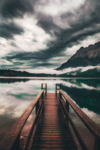 Pier over lake against sky