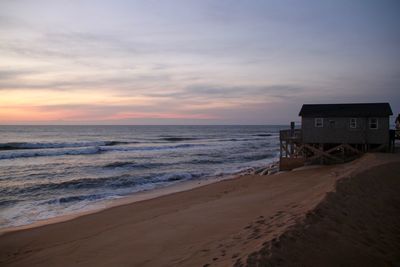 Scenic view of beach against sky during sunset