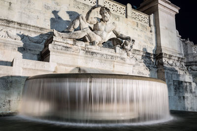 Low angle view of fountain in city