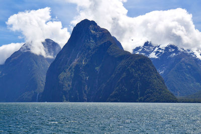 Scenic view of sea and mountains against sky