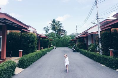 Side view of girl standing on road