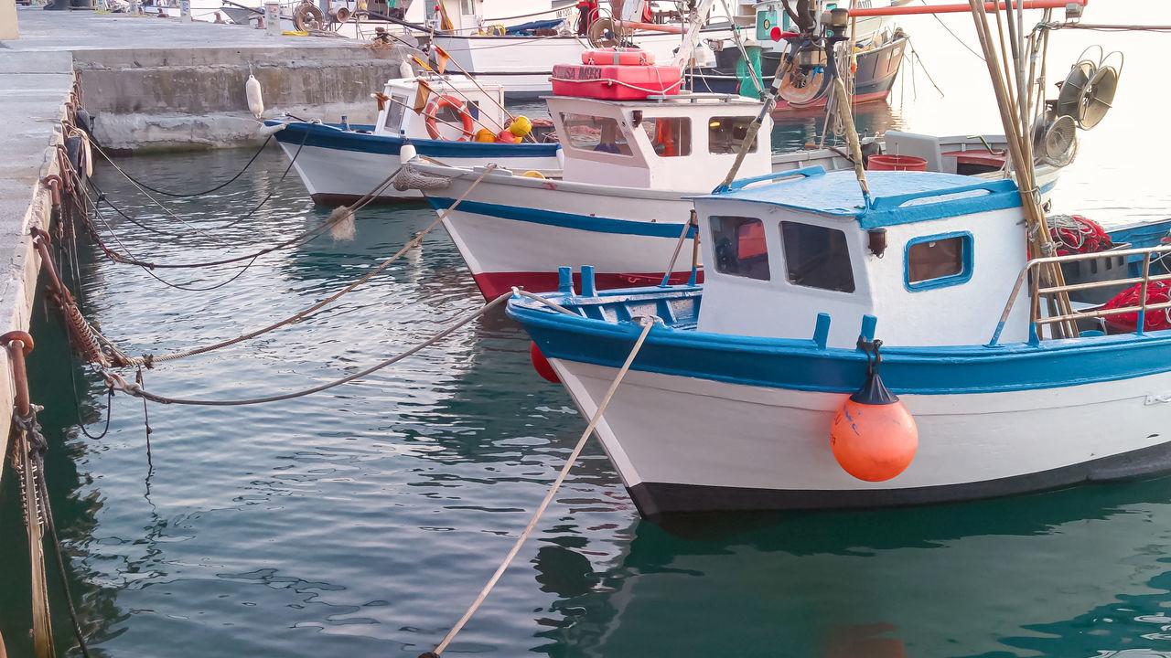 FISHING BOATS MOORED IN SEA