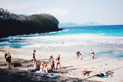 People on beach against sky