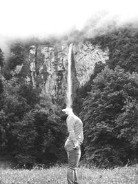 Full length of woman standing on tree trunk