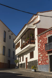 Low angle view of residential buildings against blue sky