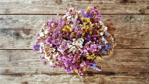 High angle view of purple flowers on wood