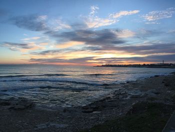 Scenic view of beach against sky during sunset