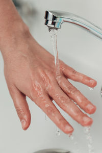 Cropped hand washing hands