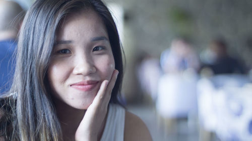 Close-up portrait of a smiling young woman