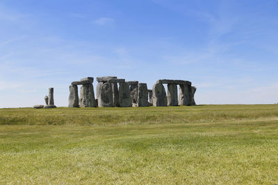 Built structure on field against sky