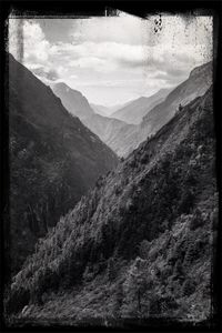 Scenic view of mountains against cloudy sky