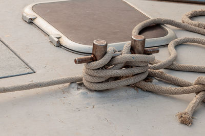 High angle view of rope tied to bollard