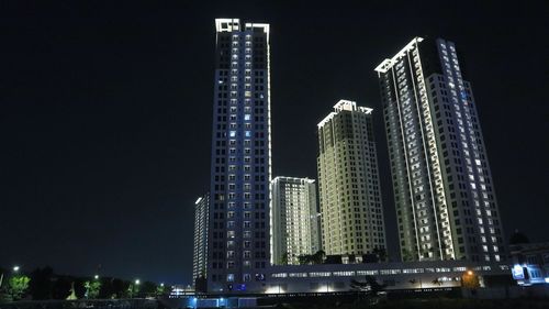 Illuminated modern buildings in city at night