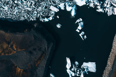 People on rock by sea