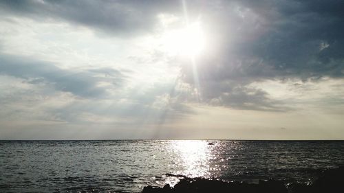 Scenic view of sea against cloudy sky