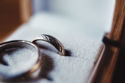 Close-up of wedding rings on table