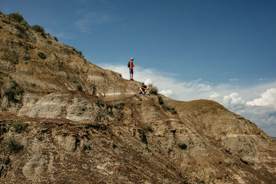 Theo teen boys standing on rock at horsethief canyon in drumheller, alberta