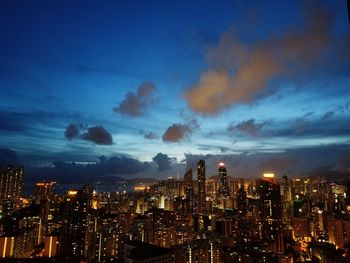 Illuminated cityscape against sky at night