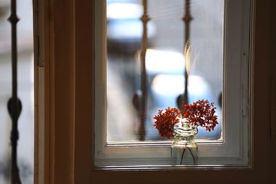 Flower vase on window sill at home