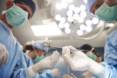 Low angle view of surgeons working in operating room