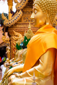 Statue of buddha against building