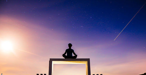 Rear view of silhouette man against clear sky