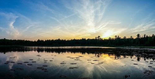 Scenic view of lake at sunset