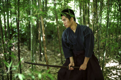 Young man standing in forest