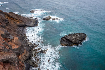 High angle view of rocks in sea