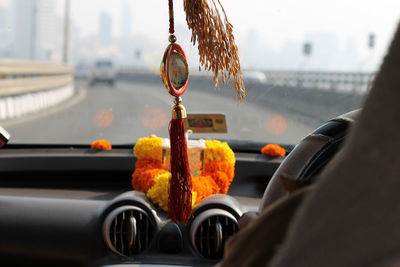 Close-up of orange car on road