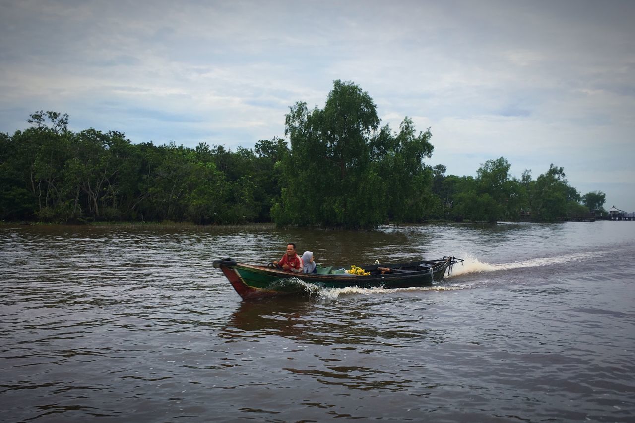 MAN ON BOAT IN RIVER