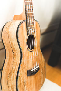 Close-up of guitar against wall