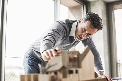 Architect working on architectural model