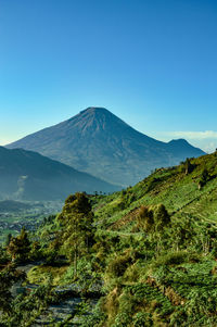 Scenic view of mountains against clear blue sky