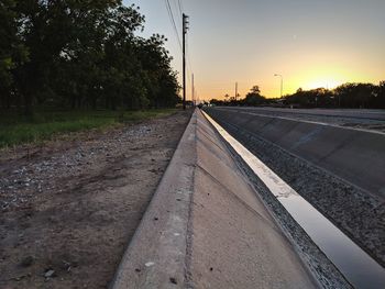 Railroad tracks by trees against sky