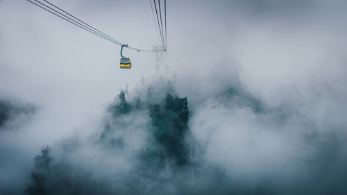 Overhead cable car against sky