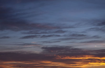 Low angle view of cloudy sky at sunset