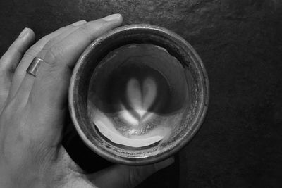 Close-up of hand holding coffee cup