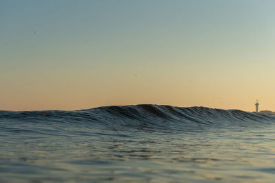 Scenic view of sea against clear sky during sunset