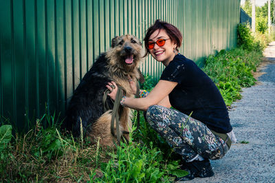 Dog at the shelter.  lonely dogs in cage with cheerful woman volunteer