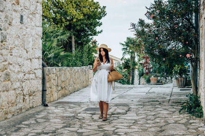 Woman standing by tree