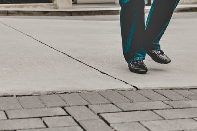 Low section of person walking on street