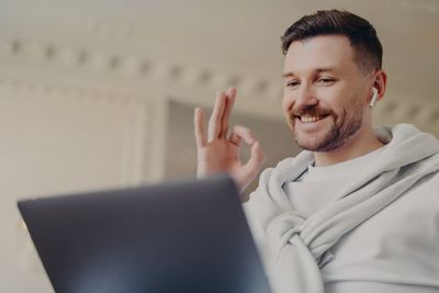 Portrait of smiling man using mobile phone