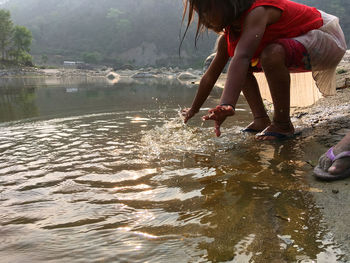 Low section of man on water in lake